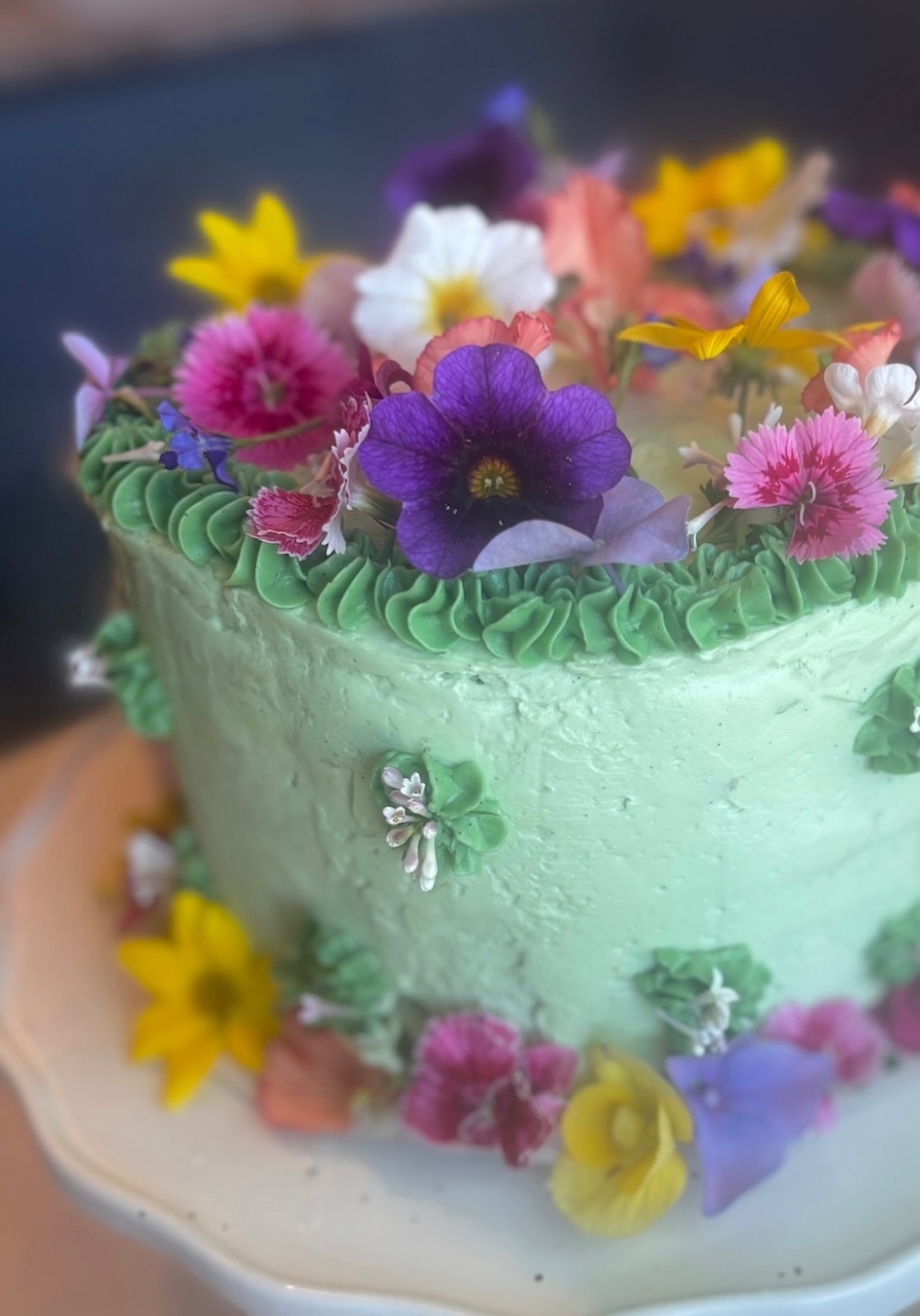 Mint green cake with colorful wildflowers
